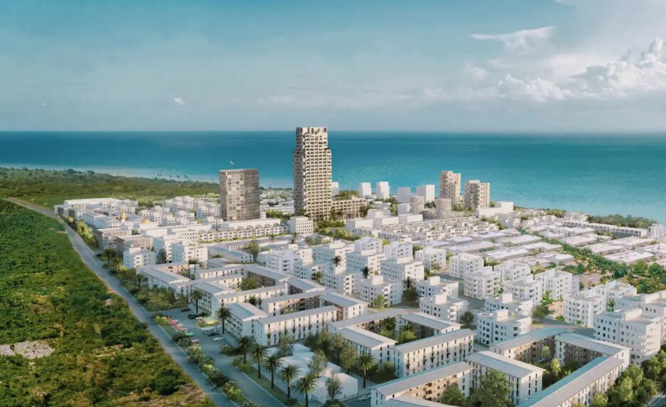 Aerial view of The Burj Zanzibar timber tower rising above Fumba Town by the Indian Ocean