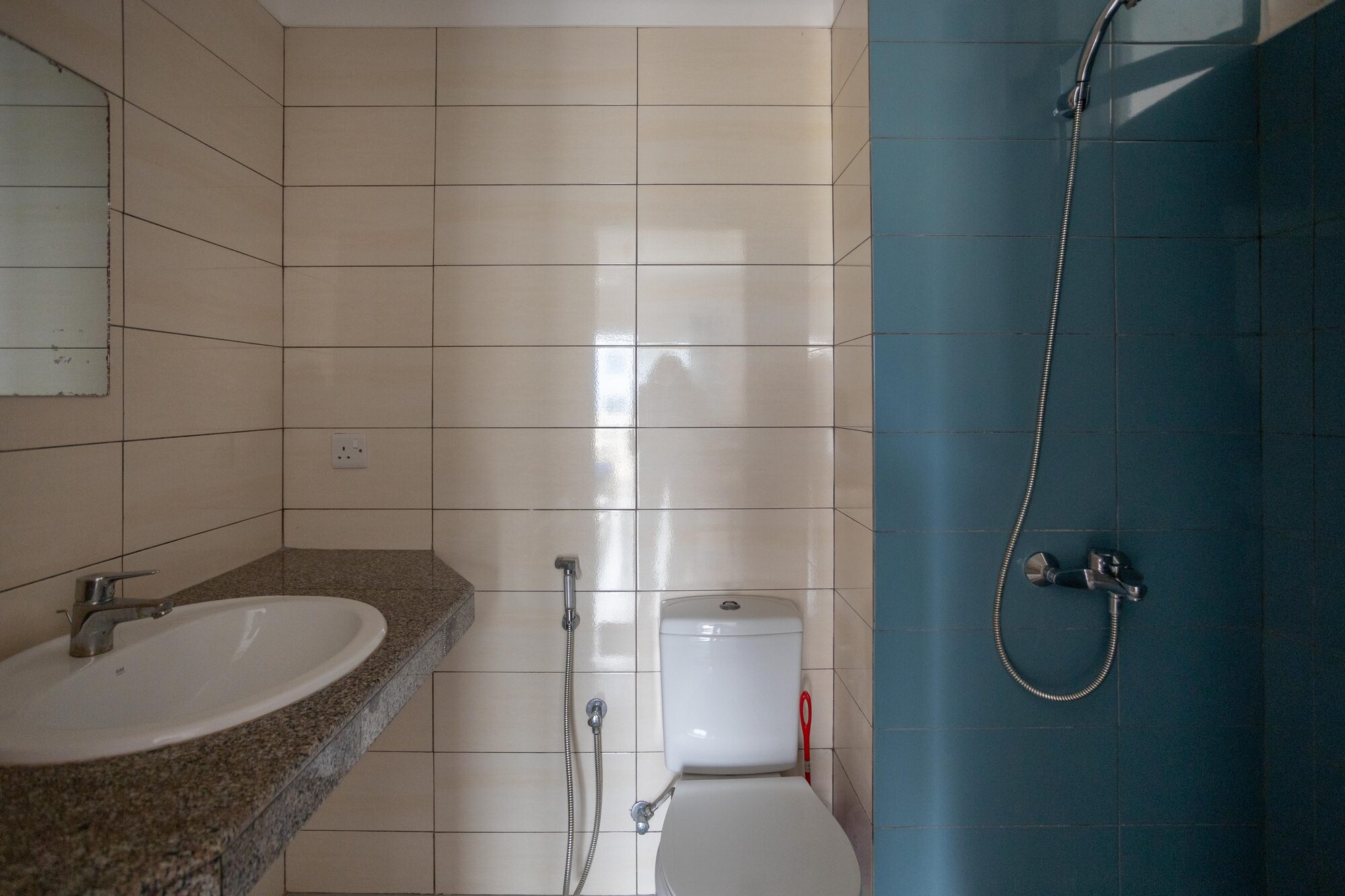 Bathroom vanity with stone counter and mirror