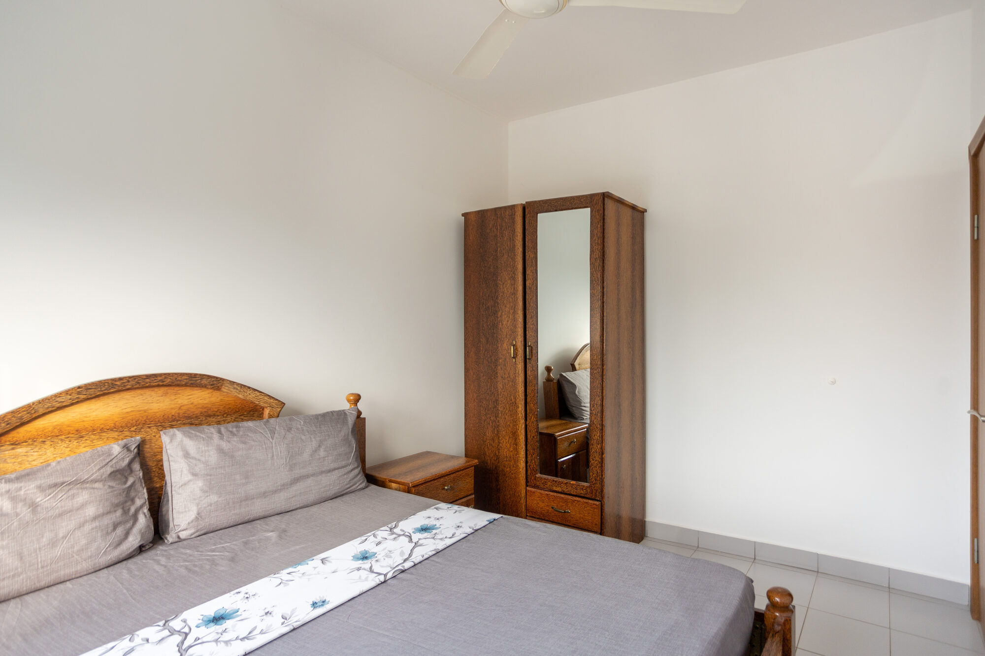 Air-conditioned main bedroom with wardrobe