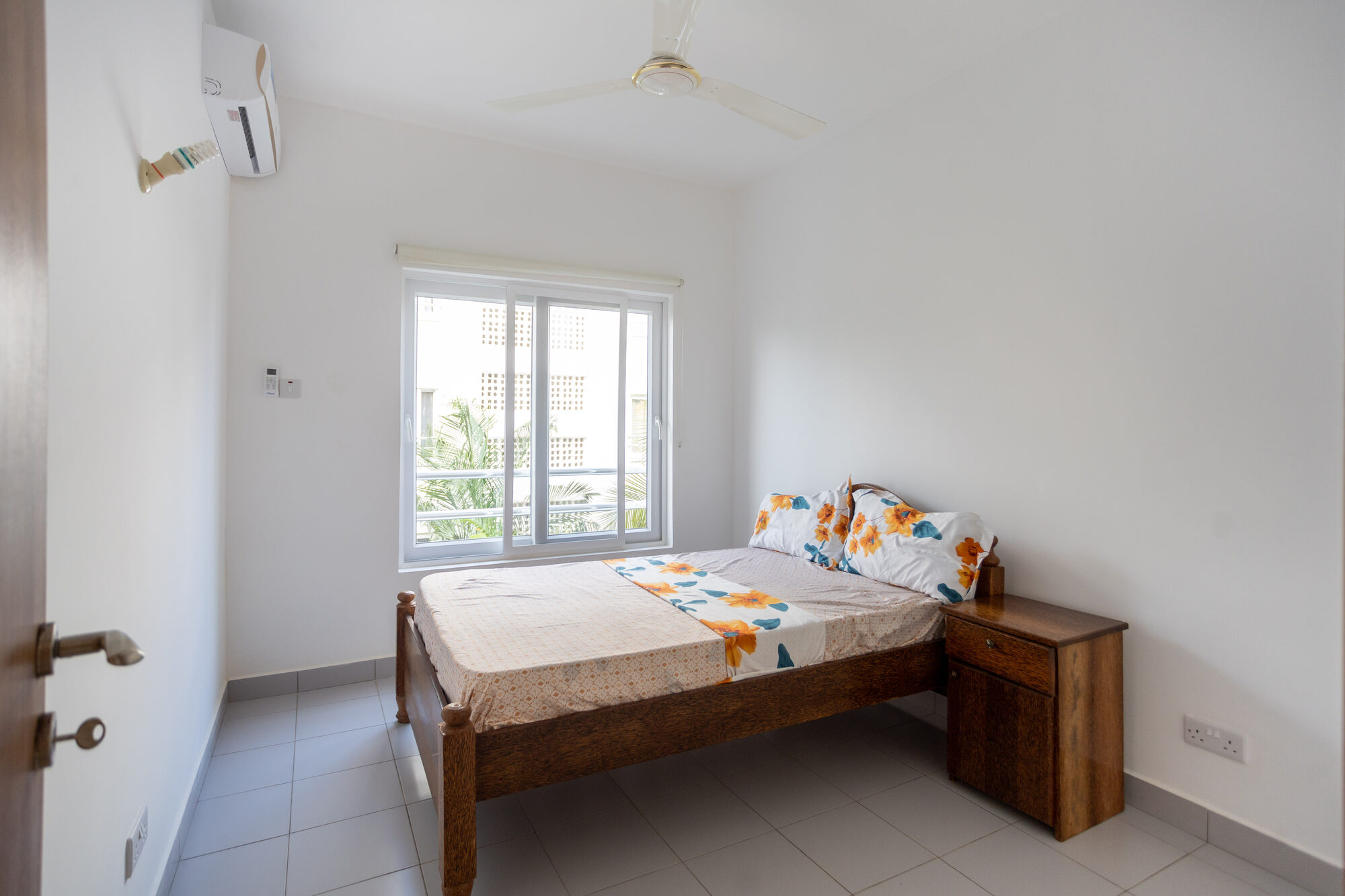 Twin bedroom with window and air conditioning