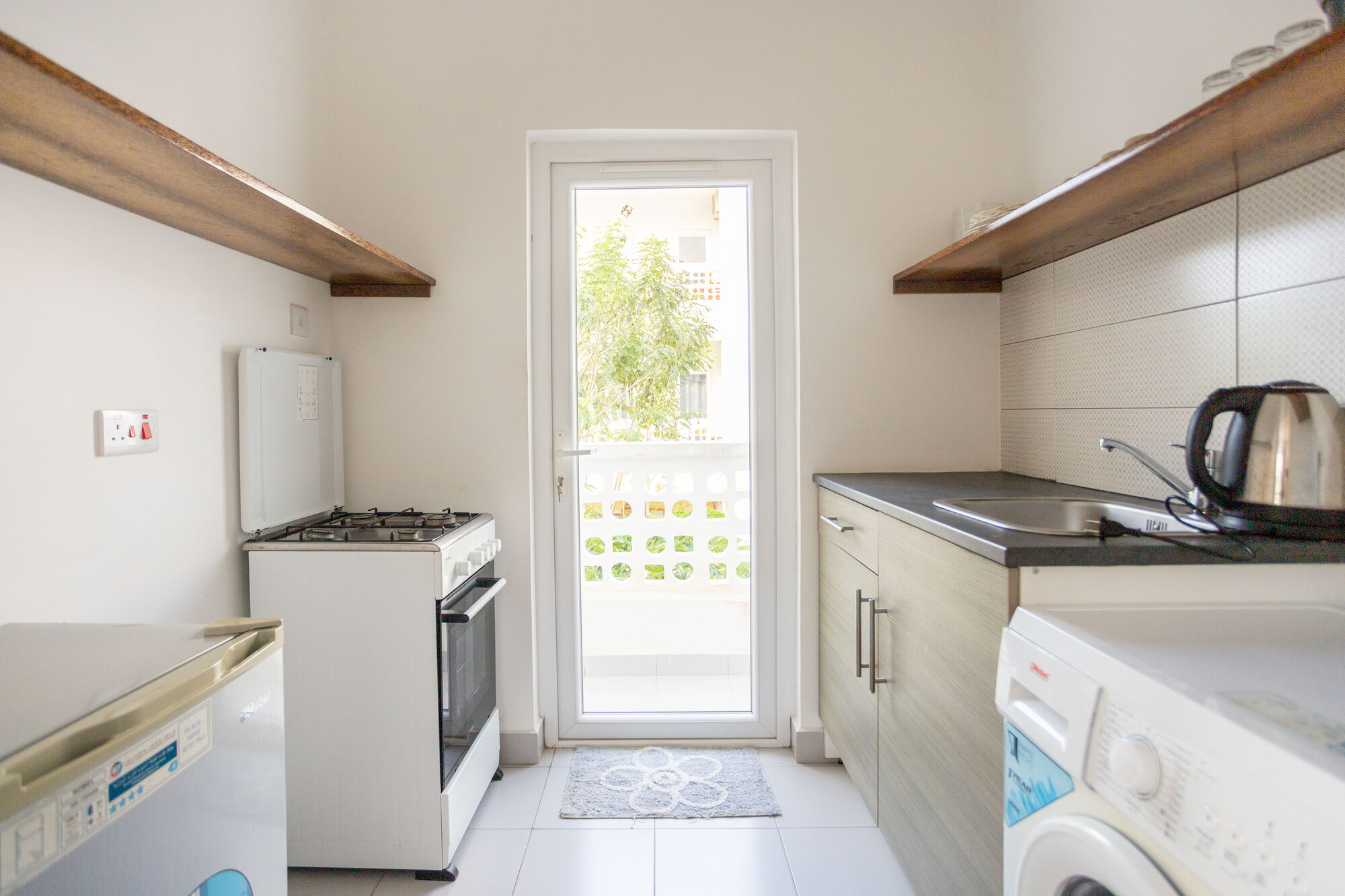 Kitchen with fridge, washing machine and cooker