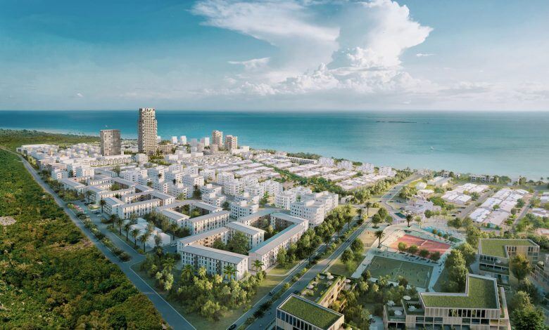 Aerial view of Fumba Town in Zanzibar with white apartment buildings beside the Indian Ocean